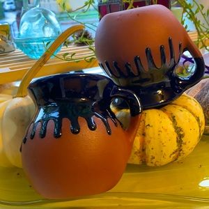 Blue/black drip glaze on orange-ish 12 oz. mugs